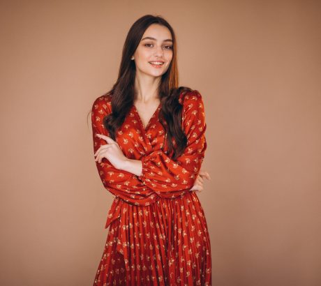 Young woman in a beautiful red dress in studio
